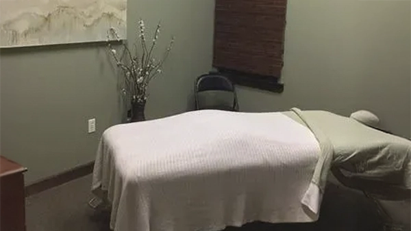 Relaxing massage therapy room with soothing colors and décor, designed to promote comfort and stress relief.